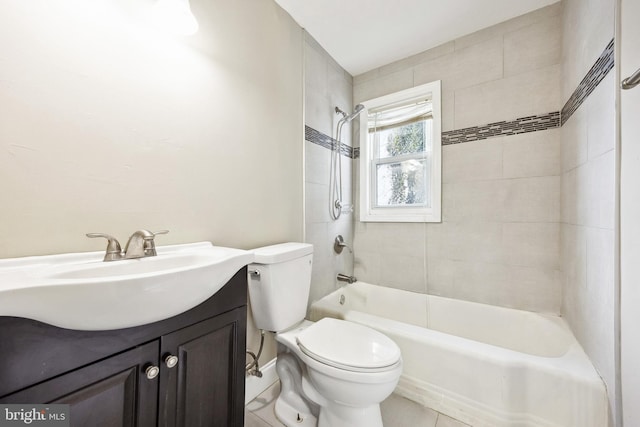 full bathroom featuring toilet, tiled shower / bath, and vanity