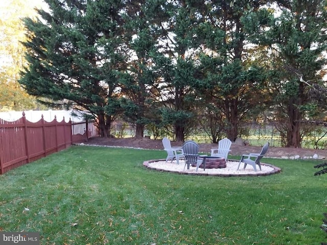 view of yard with a fire pit