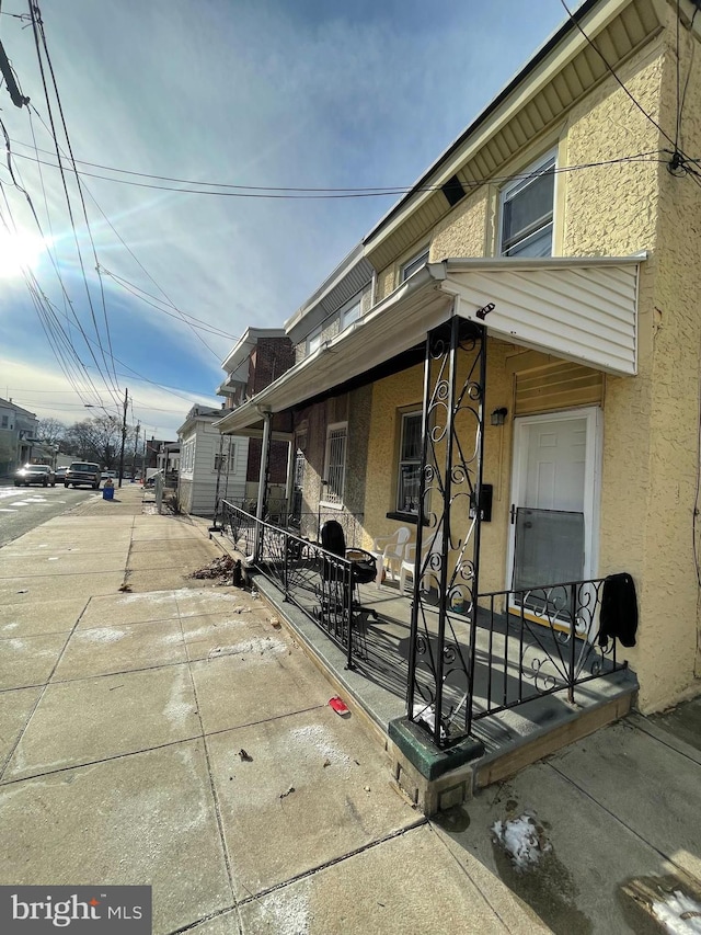 view of property exterior with a porch