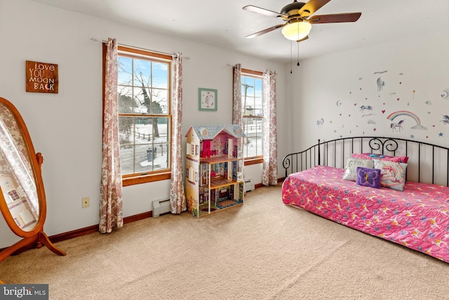 carpeted bedroom featuring ceiling fan and baseboard heating