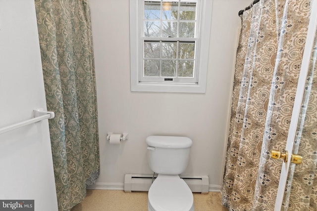 bathroom featuring a baseboard heating unit and toilet