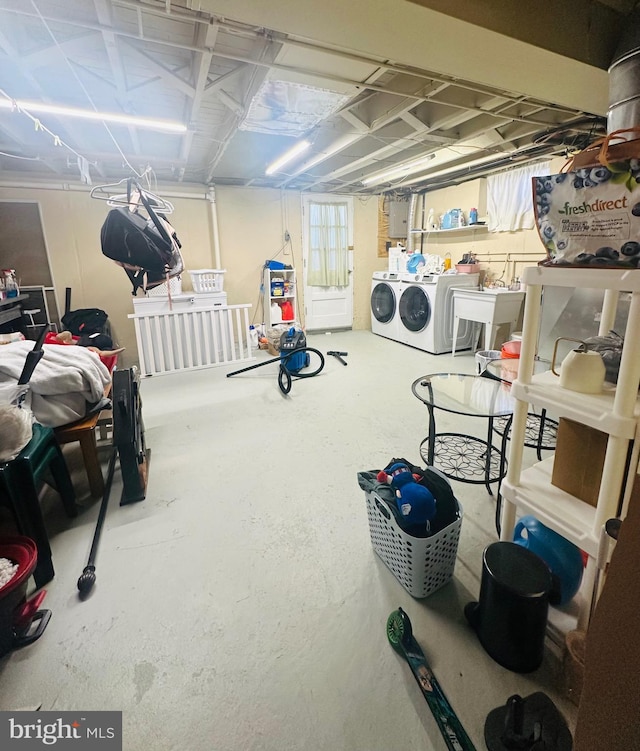 basement featuring sink and washer and dryer