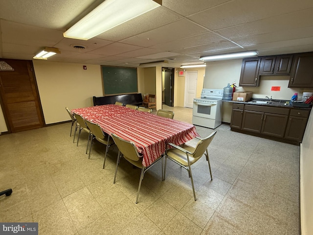 dining room featuring sink and a paneled ceiling