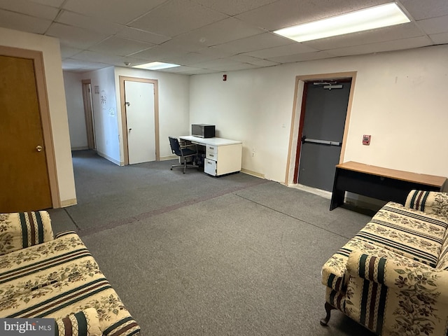 living room with a drop ceiling