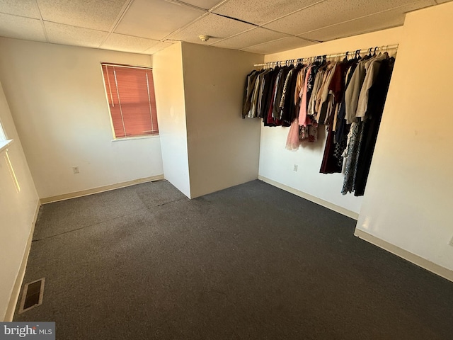 unfurnished room featuring a drop ceiling