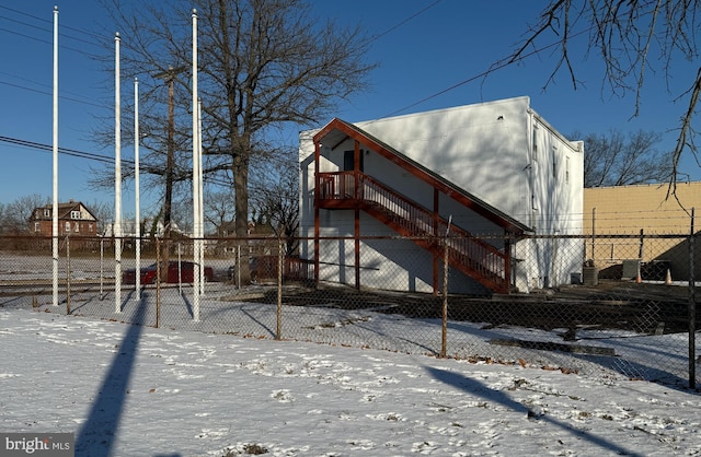 view of snow covered back of property