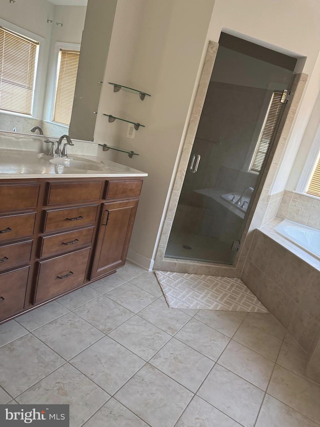 bathroom featuring vanity, a shower stall, a bath, and tile patterned floors