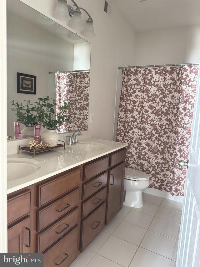 full bathroom featuring visible vents, toilet, a sink, tile patterned flooring, and double vanity