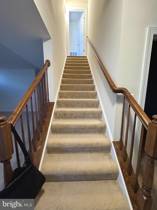 stairs featuring carpet, visible vents, and baseboards