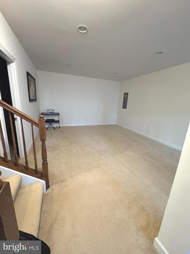 spare room featuring baseboards, stairs, and carpet