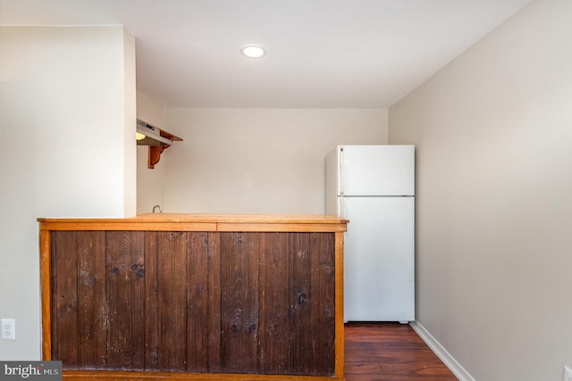 kitchen featuring dark wood-type flooring and white fridge