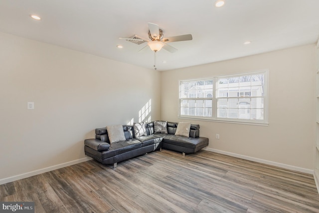 living room featuring hardwood / wood-style flooring and ceiling fan