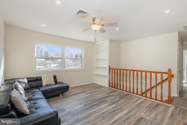 living room with ceiling fan and wood-type flooring