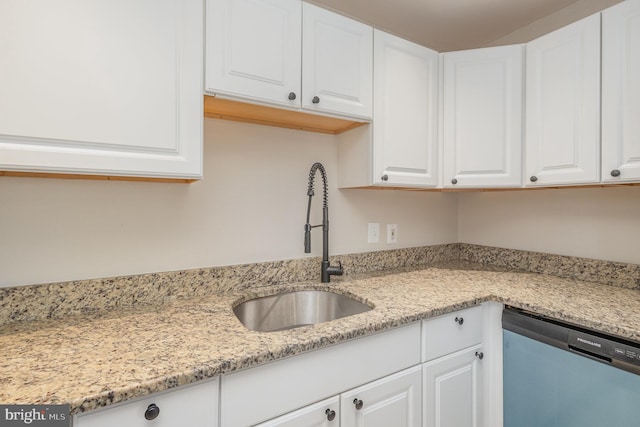 kitchen featuring light stone countertops, sink, white cabinets, and dishwasher