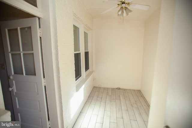 interior space featuring light hardwood / wood-style floors and brick wall