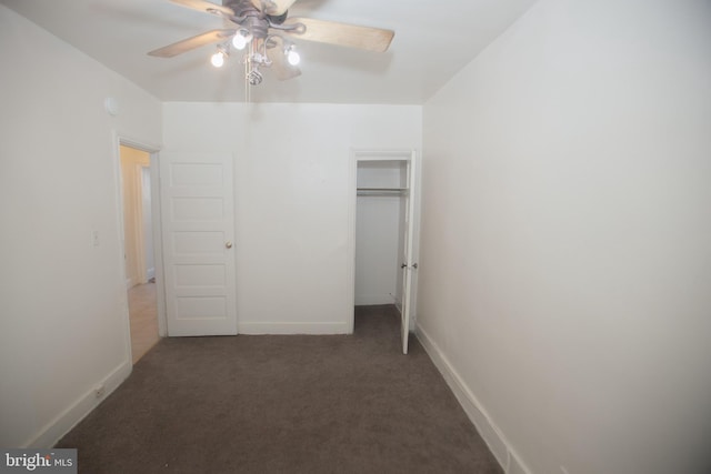 unfurnished bedroom with a closet, ceiling fan, and dark colored carpet