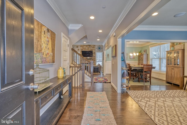 hallway with crown molding, dark wood-type flooring, and a chandelier