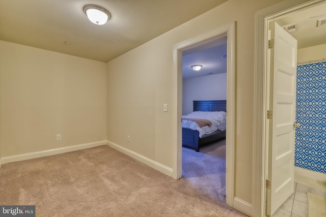 hall with light colored carpet