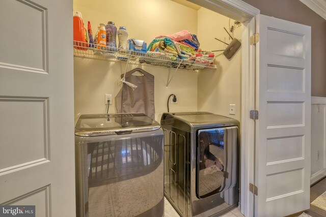 clothes washing area featuring washer and clothes dryer