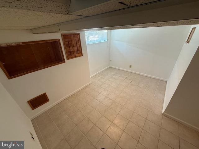 basement featuring a drop ceiling