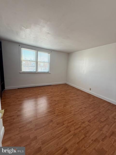 unfurnished room featuring dark hardwood / wood-style floors