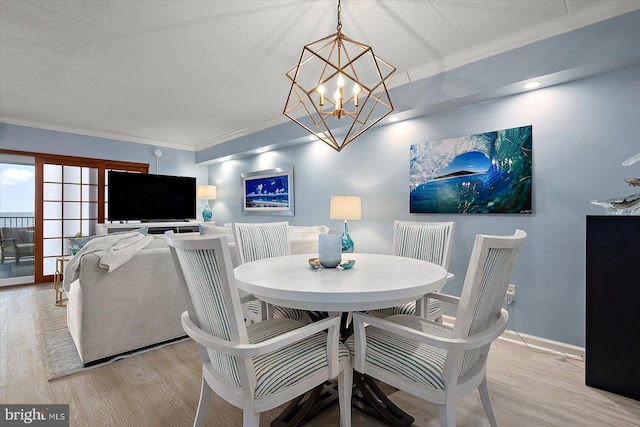 dining room featuring crown molding and light hardwood / wood-style floors