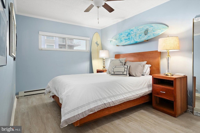 bedroom featuring a baseboard radiator, ornamental molding, ceiling fan, and light hardwood / wood-style floors