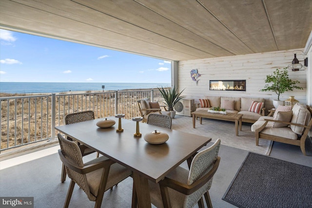 dining area with a water view and wooden walls