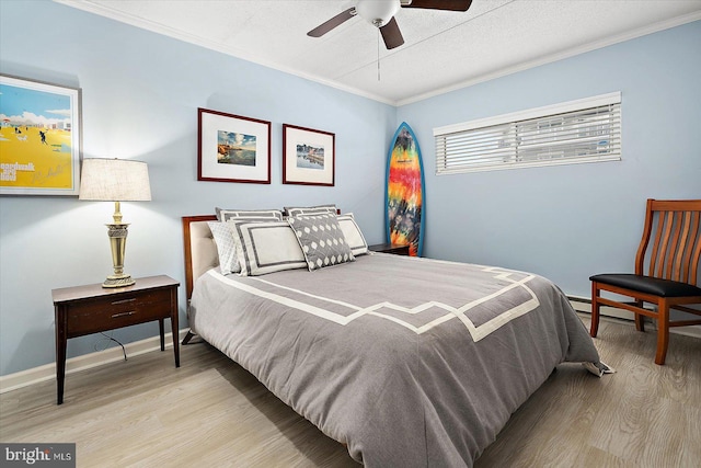 bedroom with crown molding, ceiling fan, and light wood-type flooring