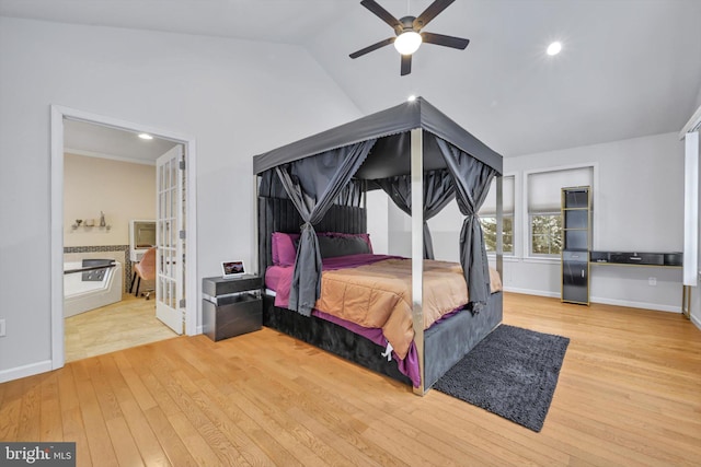 bedroom with ceiling fan, vaulted ceiling, ensuite bathroom, and light hardwood / wood-style floors