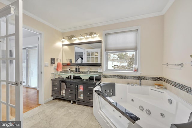 bathroom featuring tiled tub, vanity, crown molding, and french doors