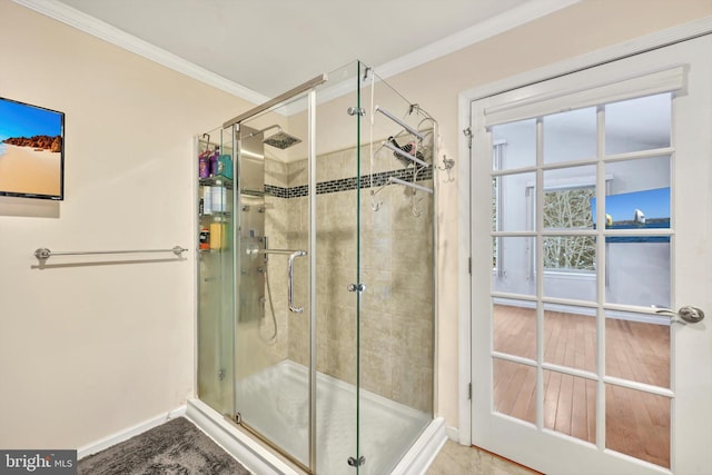 bathroom with ornamental molding and an enclosed shower