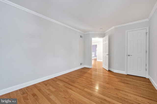 unfurnished room featuring light wood-type flooring and ornamental molding