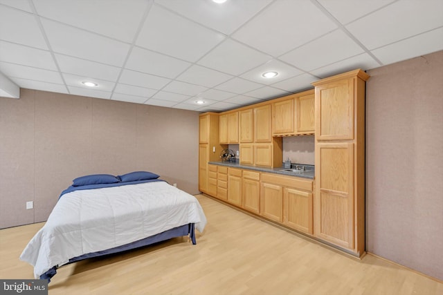 bedroom featuring sink and light hardwood / wood-style floors