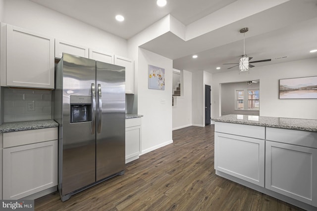 kitchen featuring backsplash, white cabinets, stainless steel fridge with ice dispenser, light stone countertops, and dark hardwood / wood-style floors