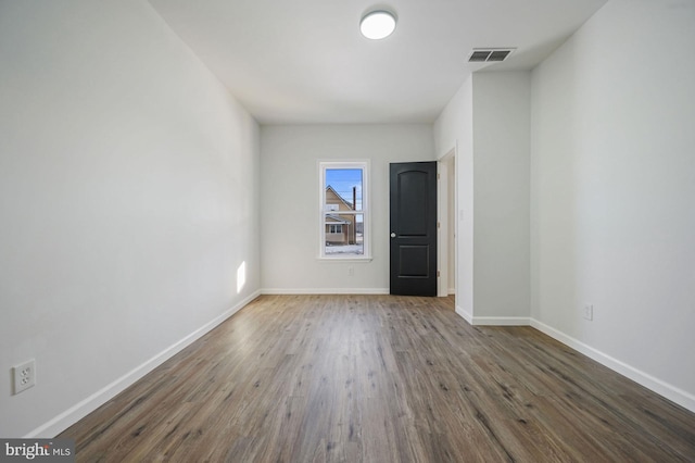 unfurnished room featuring dark hardwood / wood-style floors