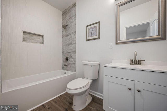 full bathroom with vanity, toilet, hardwood / wood-style floors, and tiled shower / bath