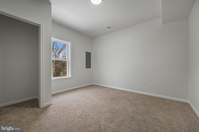 empty room with carpet floors and electric panel