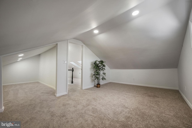 bonus room featuring light carpet and lofted ceiling