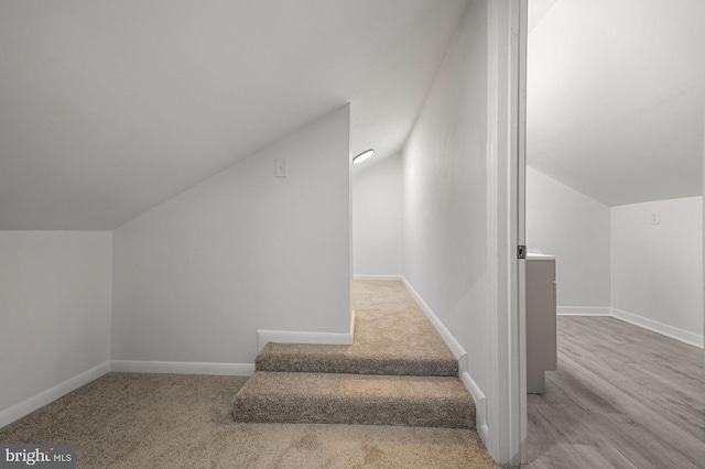 stairway featuring vaulted ceiling