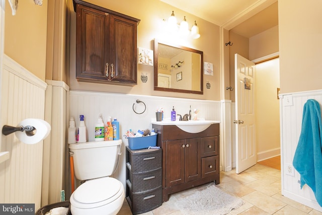 bathroom featuring vanity, tile patterned floors, and toilet