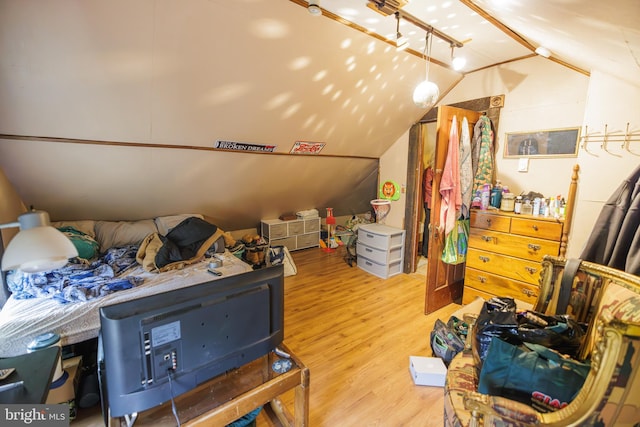 interior space featuring hardwood / wood-style flooring and vaulted ceiling