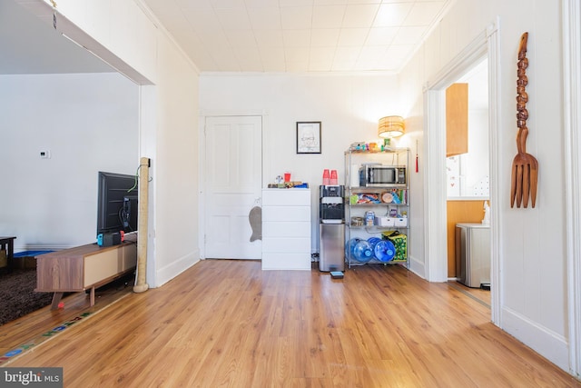 miscellaneous room featuring light hardwood / wood-style flooring and ornamental molding