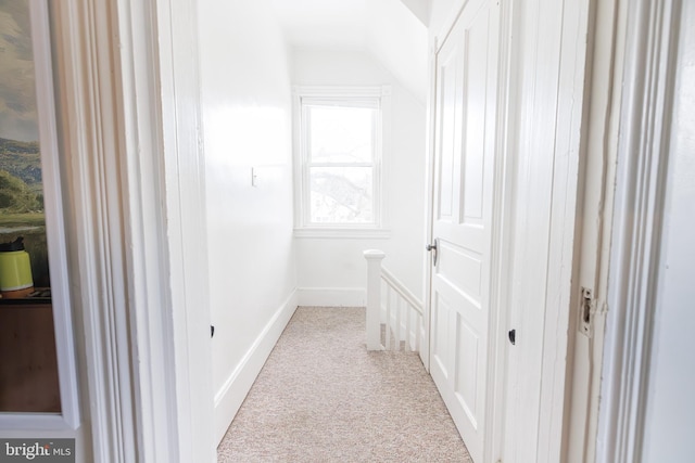 hall with light colored carpet