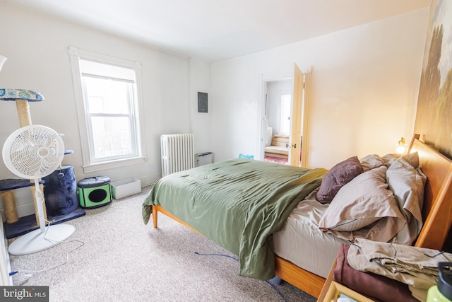 bedroom featuring radiator heating unit and carpet flooring