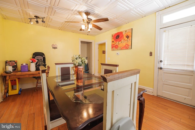 dining area with wood-type flooring and ceiling fan