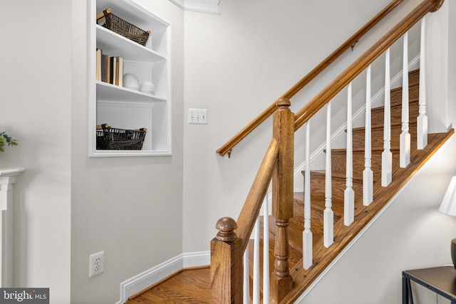 staircase featuring wood-type flooring