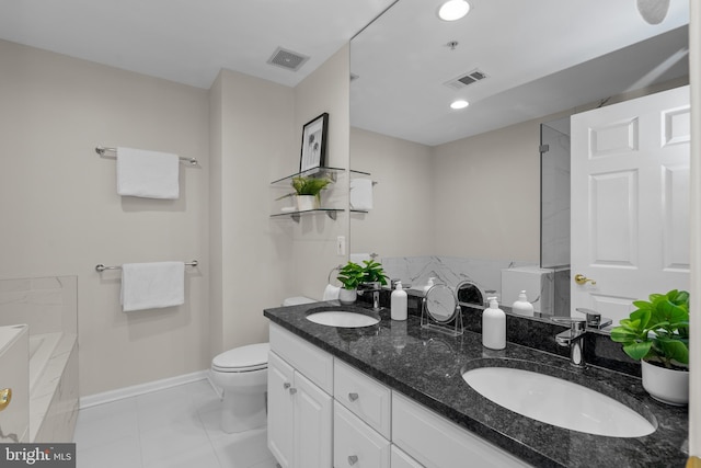 bathroom with vanity, toilet, a tub, and tile patterned flooring