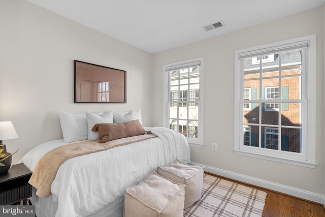 bedroom with hardwood / wood-style flooring