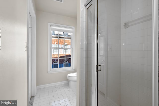 bathroom with toilet, an enclosed shower, and tile patterned flooring